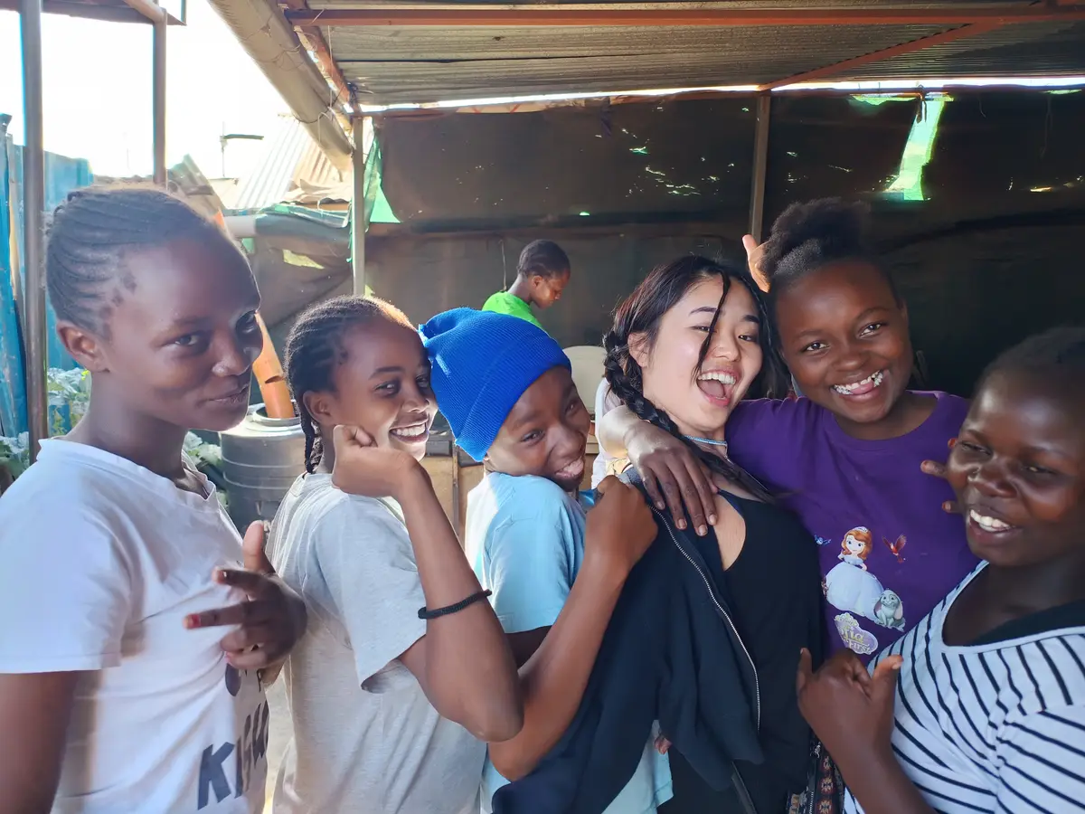 A HUSM student and Kenyan youth sharing a relaxed moment